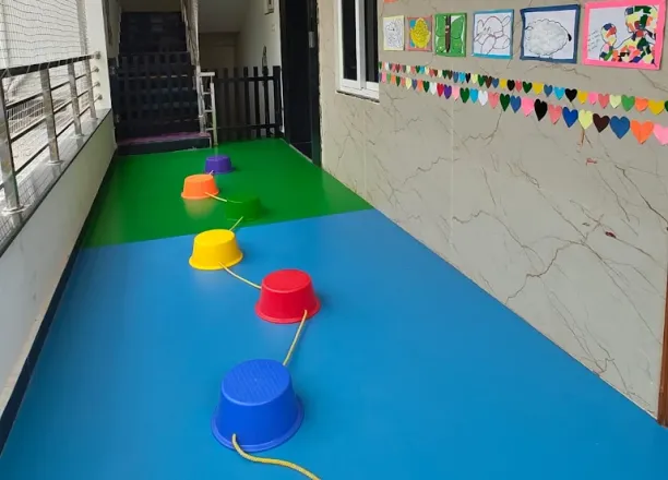 Stepping-stone activity path and children's artwork at Cherubs Kondapur