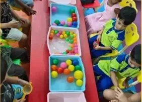 Small group of children doing a ball-sorting activity at Cherubs Kondapur